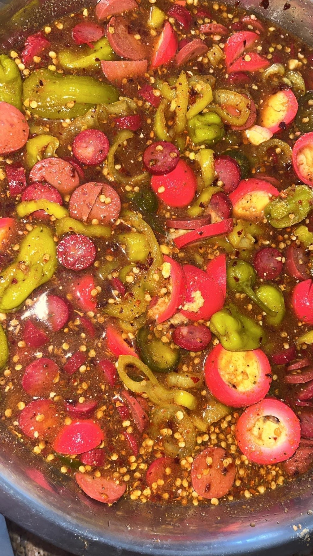 Spicy sausage with peppers in seasoned broth