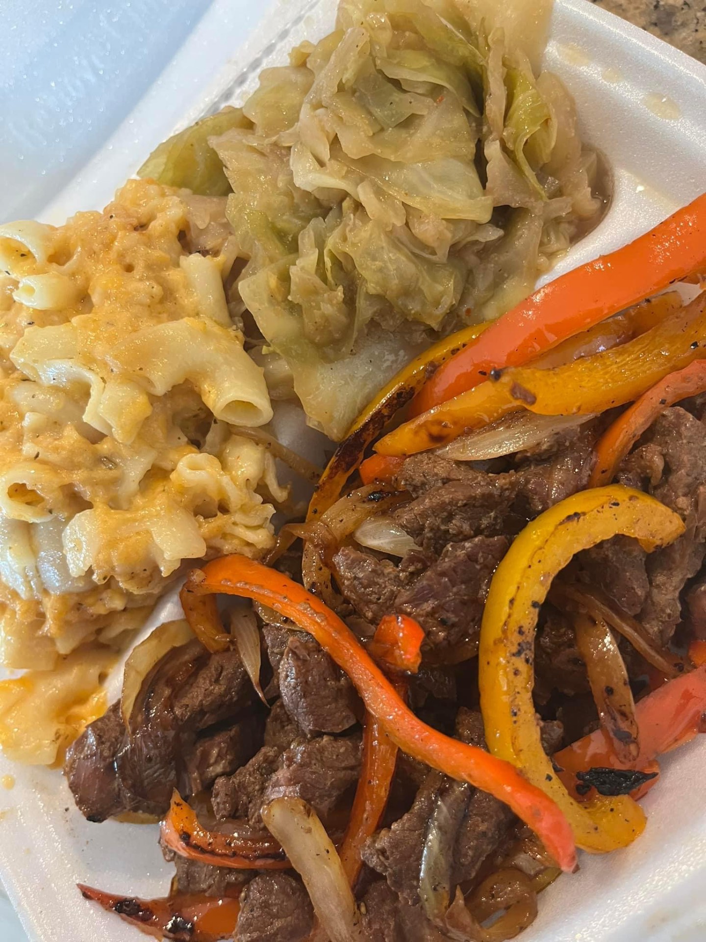 Steak and peppers with mac and cheese and cabbage