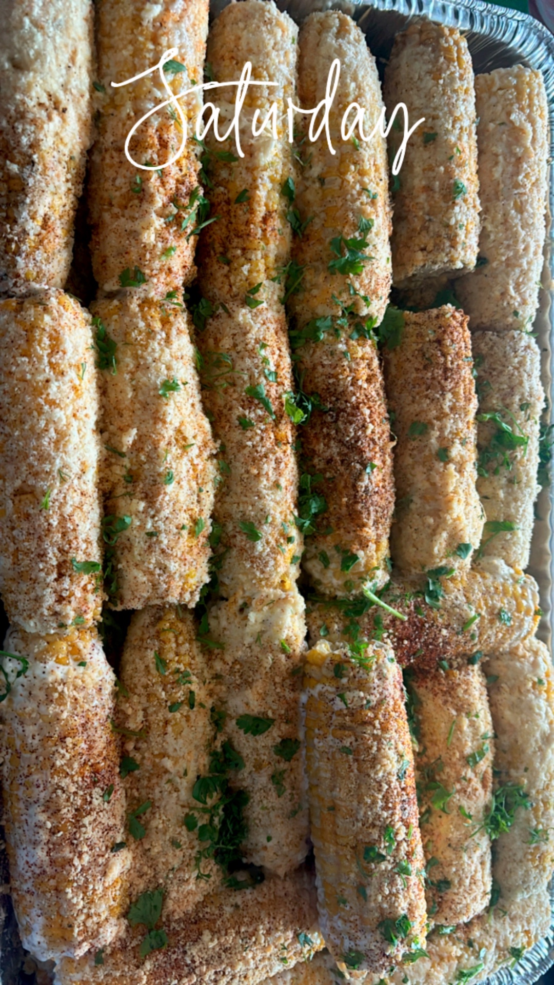 Tray of street corn dusted with parmesan and cilantro